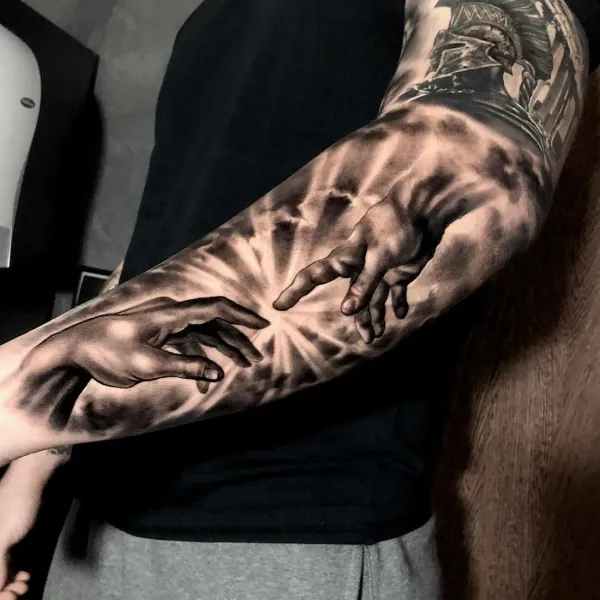 Realistic Tattoo Berlin: Michelangelos Hände als Black-and-Grey-Sleeve auf dem Unterarm, LAKIMII Studio